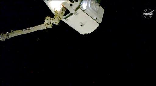In this image taken from NASA Television, the SpaceX Dragon cargo spacecraft is captured by a robotic arm for docking to the International Space Station, Saturday, Dec. 8, 2018. A SpaceX delivery full of Christmas goodies has arrived at the International Space Station. The Dragon capsule pulled up at the orbiting lab Saturday, three days after launching from Florida. [Photo: AP/ NASA TV]