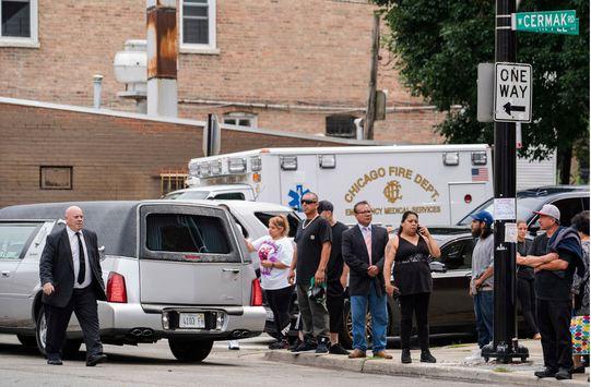 Family and friends of the Little Village fire victims, as well as media, stand outside Our Lady Of Tepeyac church as the hearses carrying the victims drive away in Chicago on Saturday, Sept. 1, 2018. The fire early Sunday, Aug. 26, 2018 was the city's deadliest blaze in more than a decade. It started in the rear of an apartment building during a sleepover, killing 14-year-old Cesar Contreras, 13-year-old Nathan Contreras, 11-year-old Xavier Contreras, 5-year-old Ariel Garcia, 3-month-old Amayah Almaraz and their cousin, 14-year-old Adrian Hernandez. [Photo: AP/Max Herman/Chicago Sun-Times]