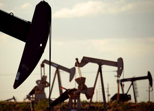 FILE - In this April 24, 2015 file photo, pumpjacks work in a field near Lovington, N.M. The United States may have reclaimed the title of the world's biggest oil producer sooner than expected. The U.S. Energy Information Administration said Wednesday that America